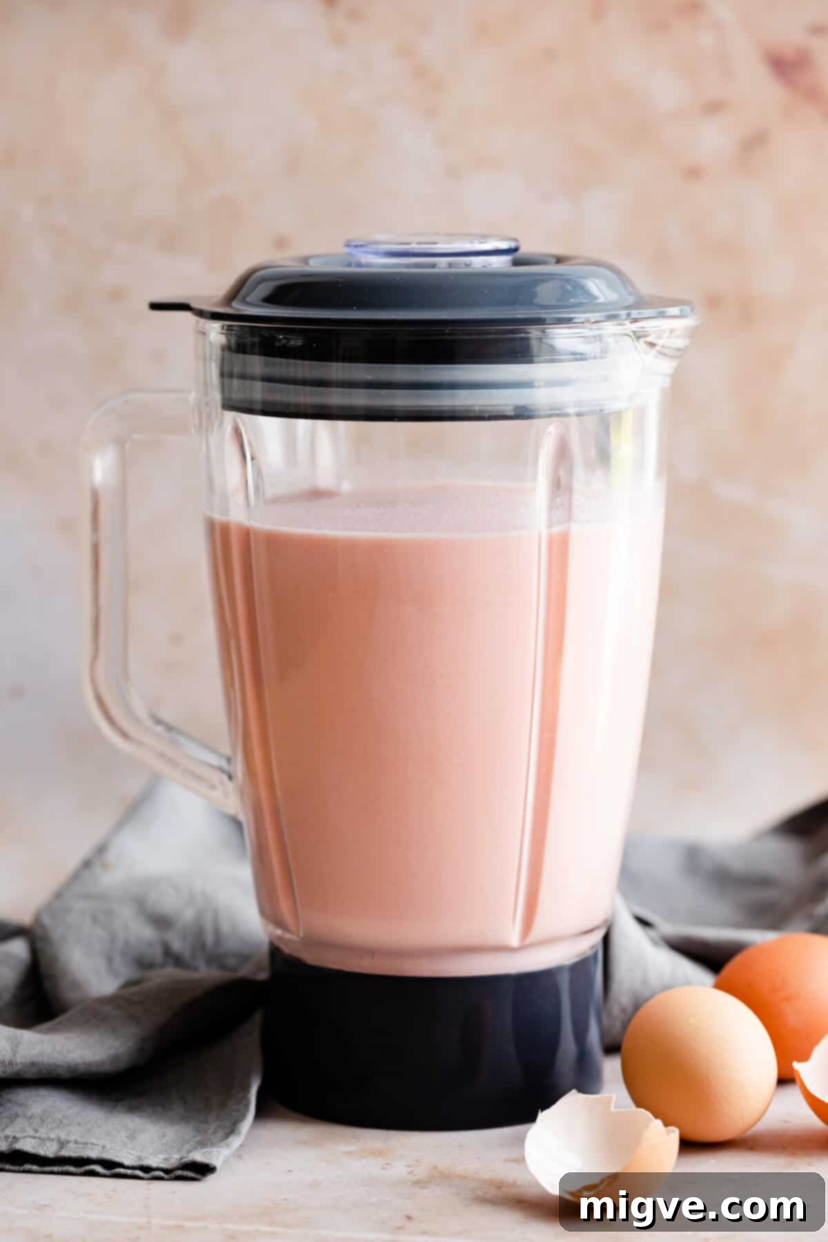 straight ahead shot of a blender jar filled with pink crepe batter