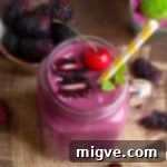 Deep Berry Cherry Delight 4 Close-up of a blackberry and cherry smoothie in a jar