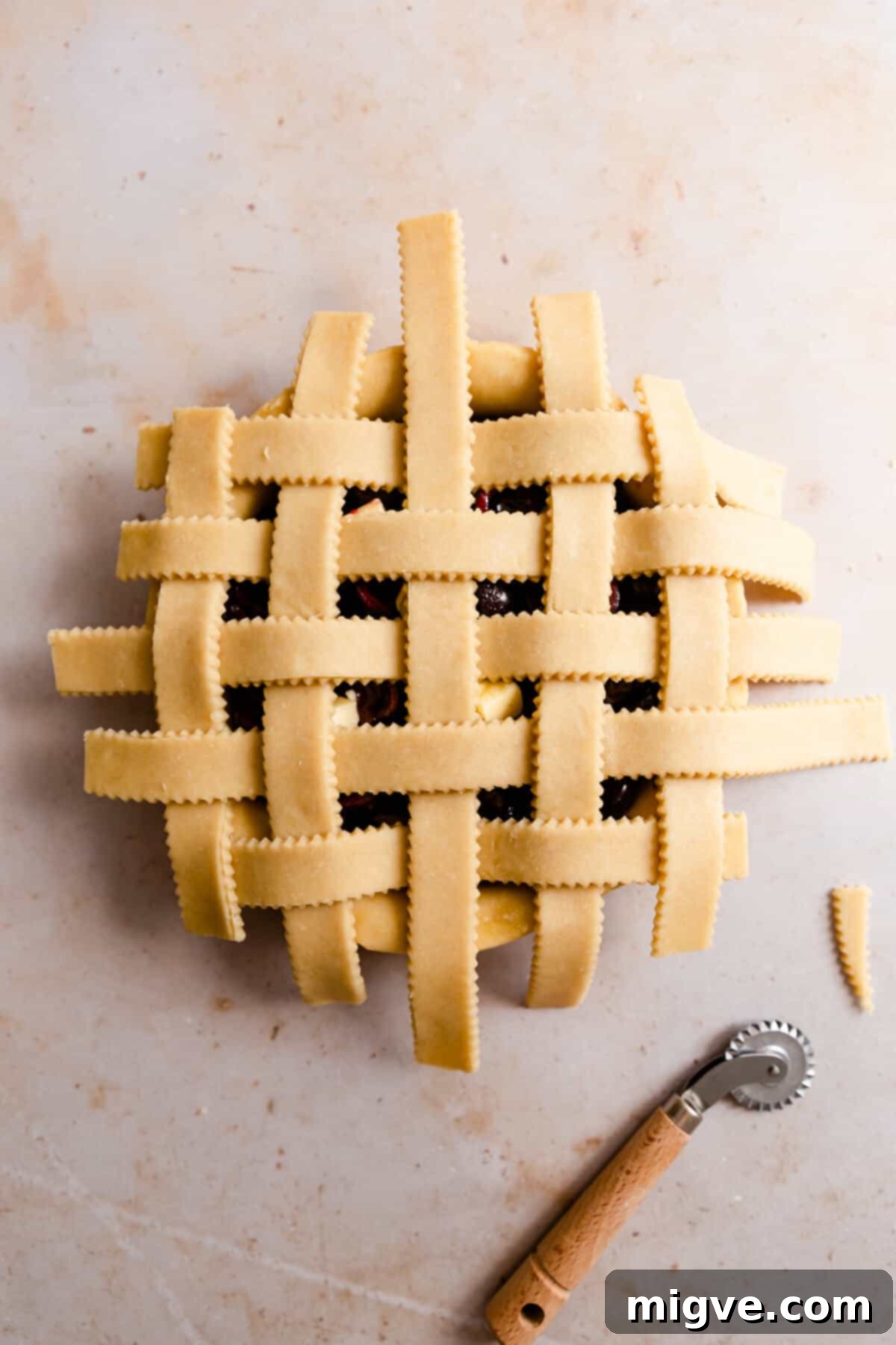 overhead shot of a unbaked pastry lattice on top of the cherry filling