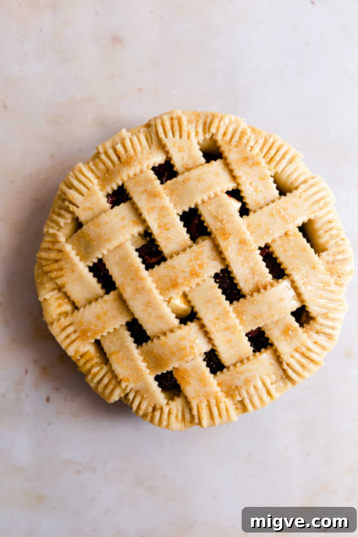 top view of unbaked pie with some sugar sprinkled on top of it