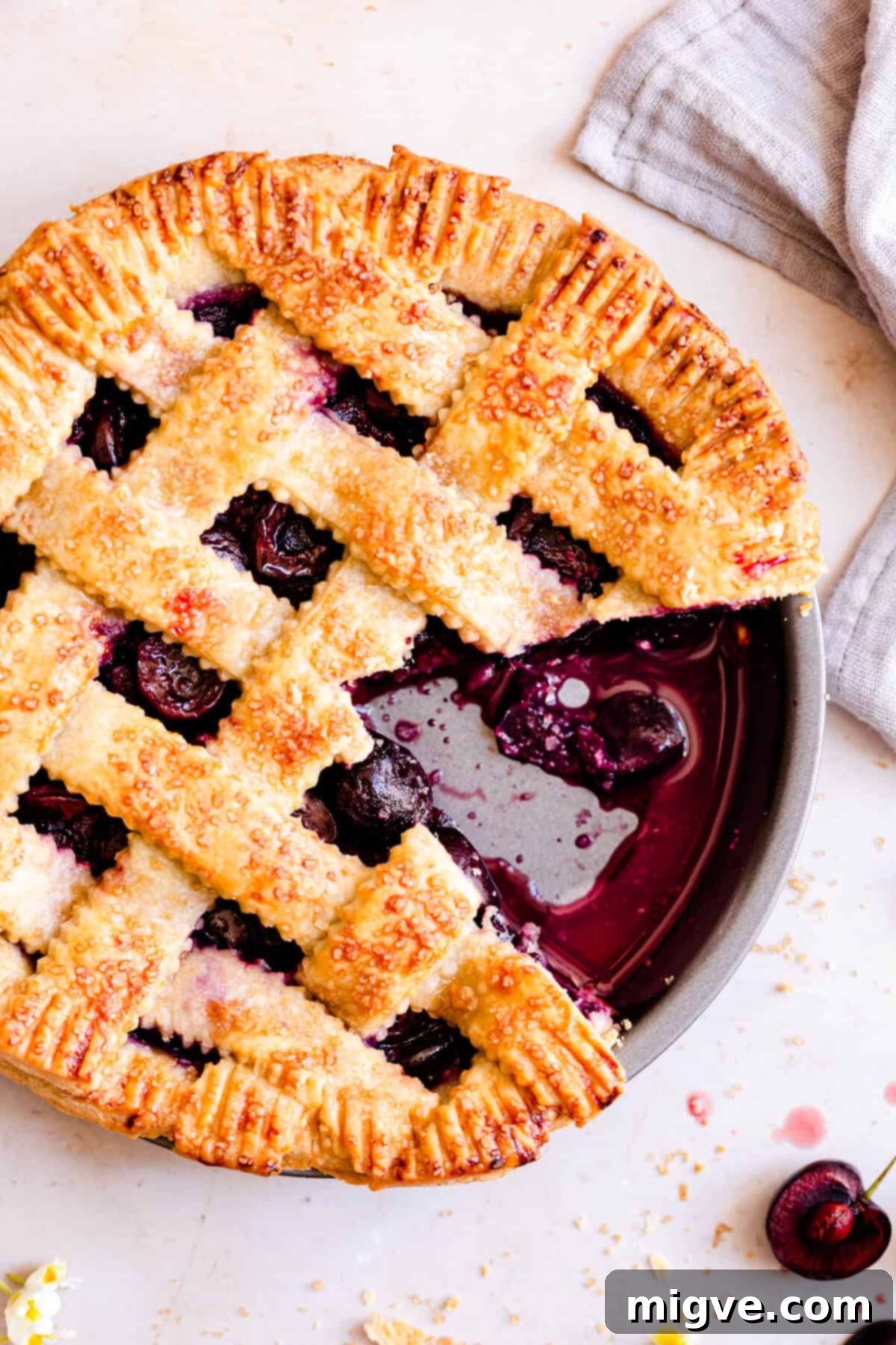 overhead shot of homemade pie with cherries with a slice taken out