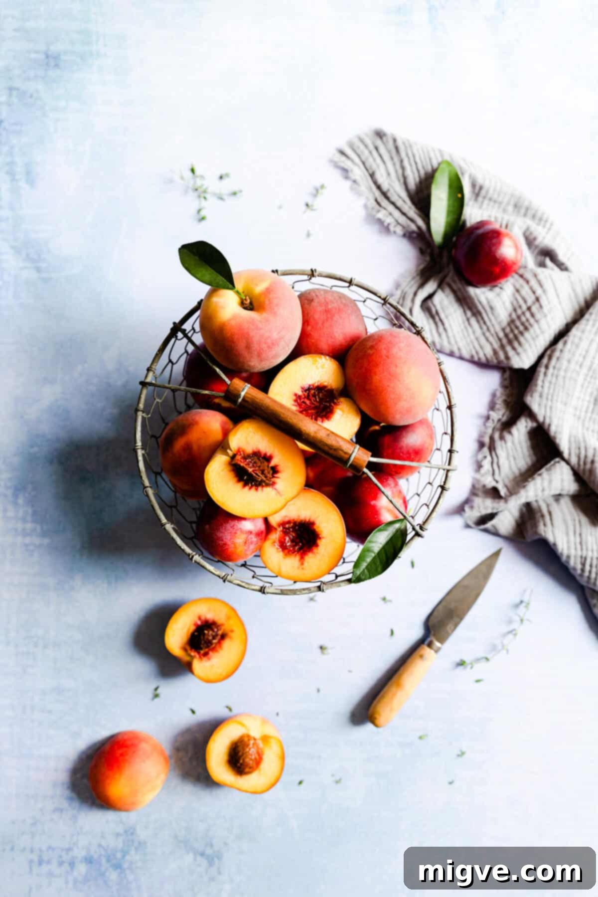 top view of wire basket filled with fresh, ripe peaches for baking a delicious galette