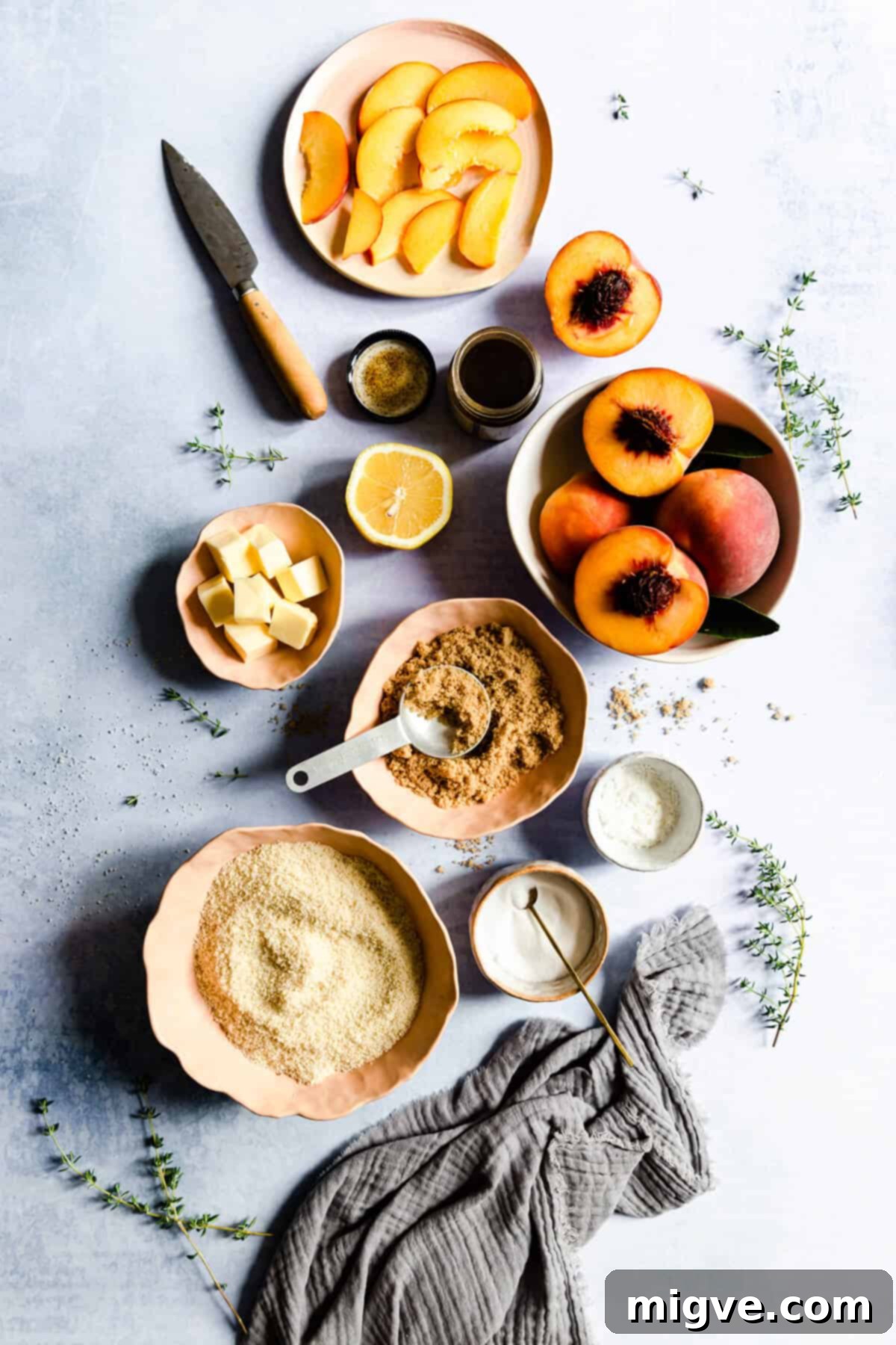 top view of organized peach galette ingredients, including flour, butter, and peaches