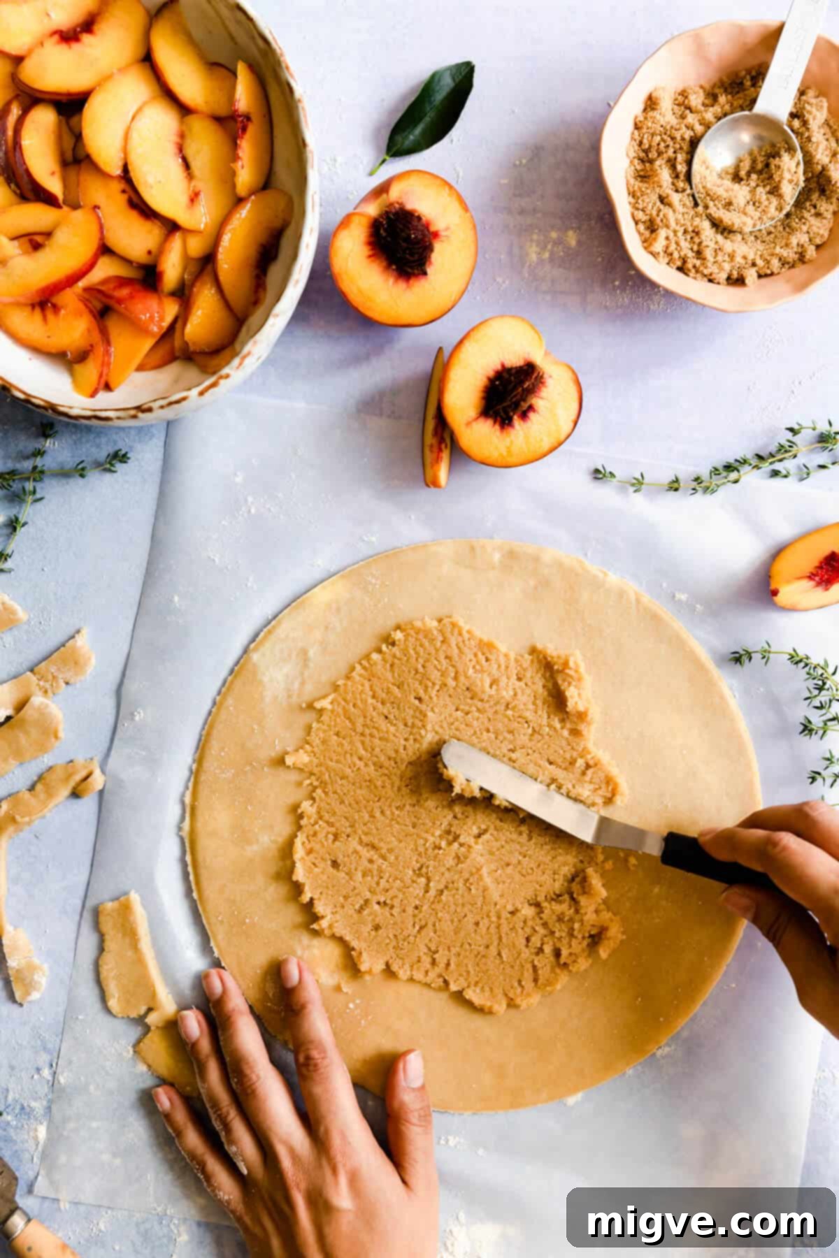 frangipane filling being smoothly spread onto galette dough, leaving a border
