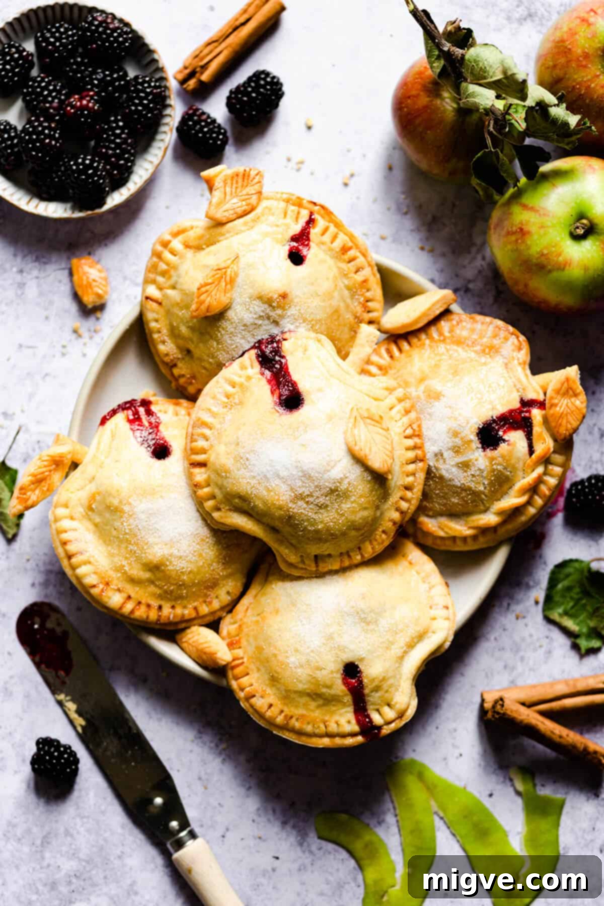 top view of a plate with 5 apple and blackberry hand pies