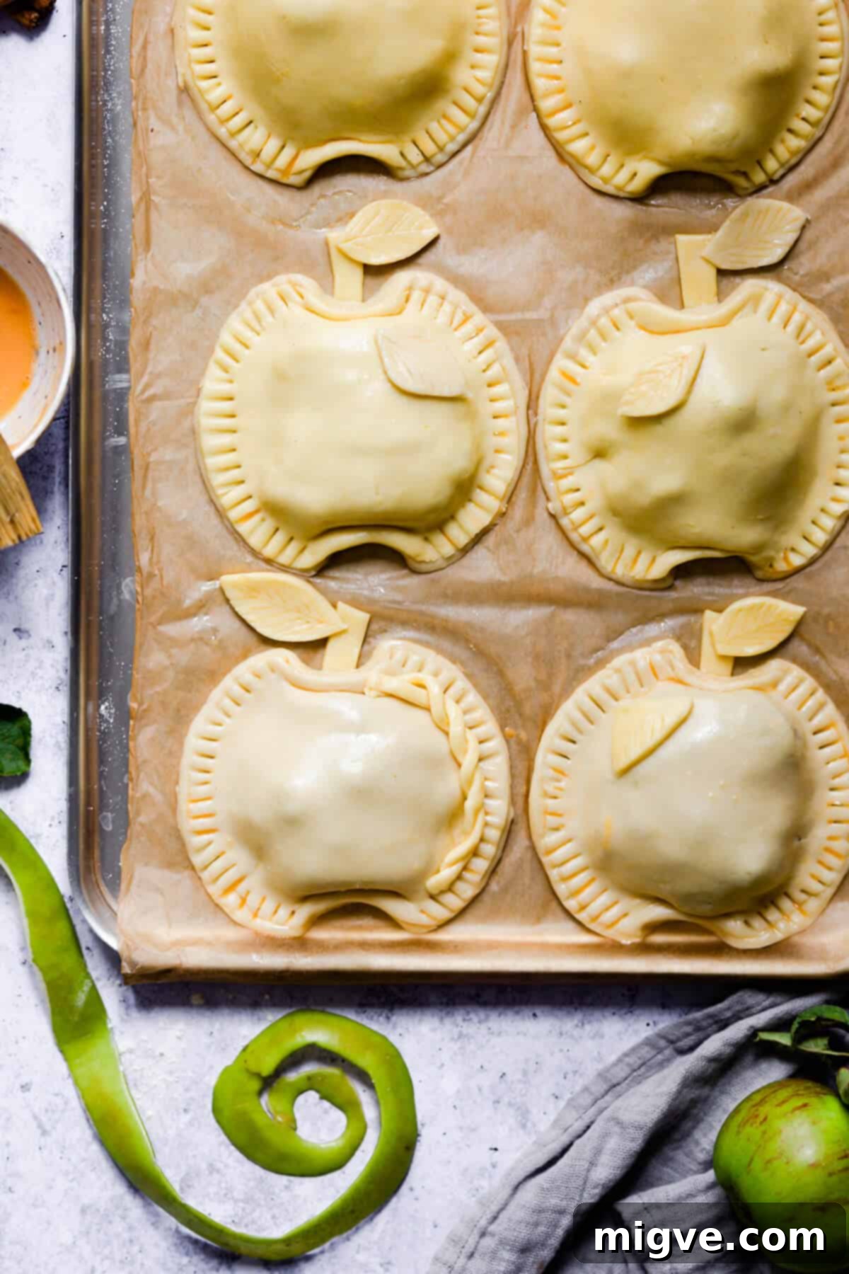 overhead shot of spiced apple and blackberry hand pies on a baking tray