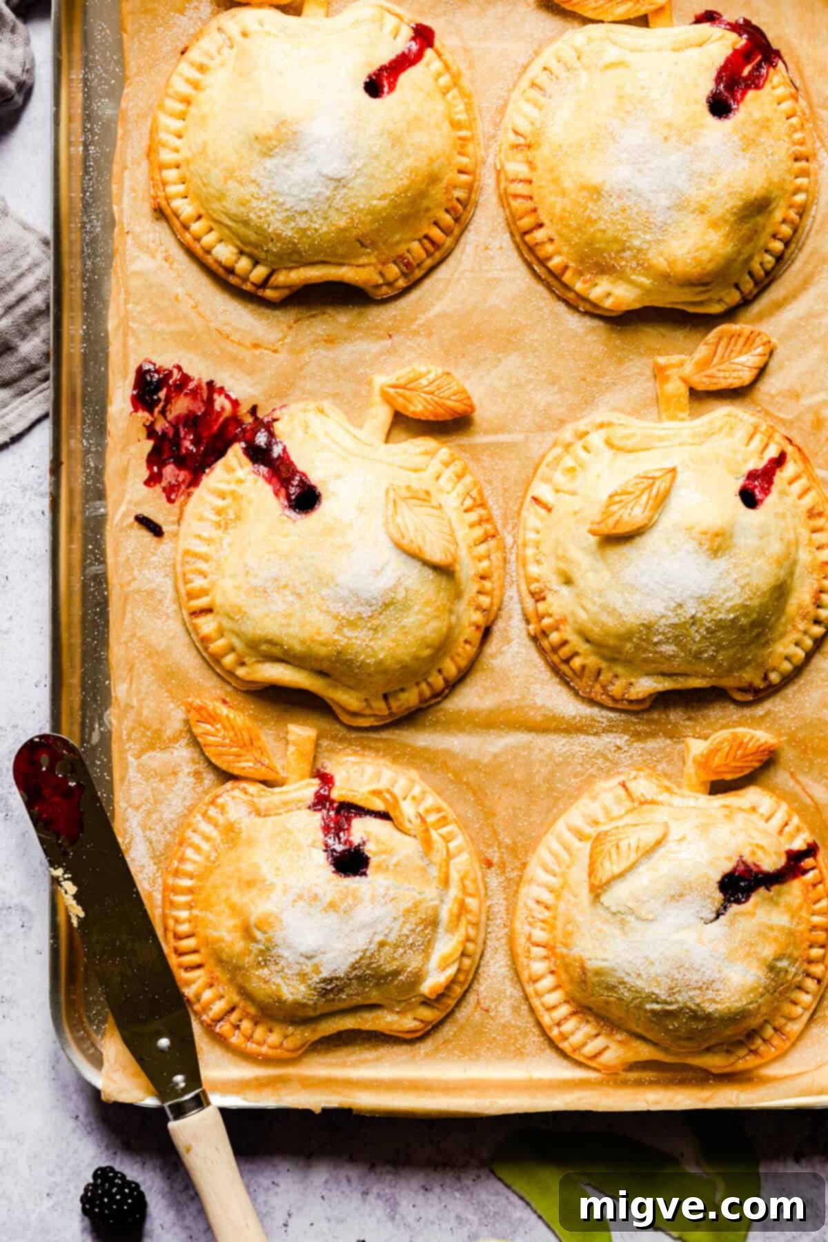 top view close-up of baked spiced apple and blackberry hand pies with some juices oozing out