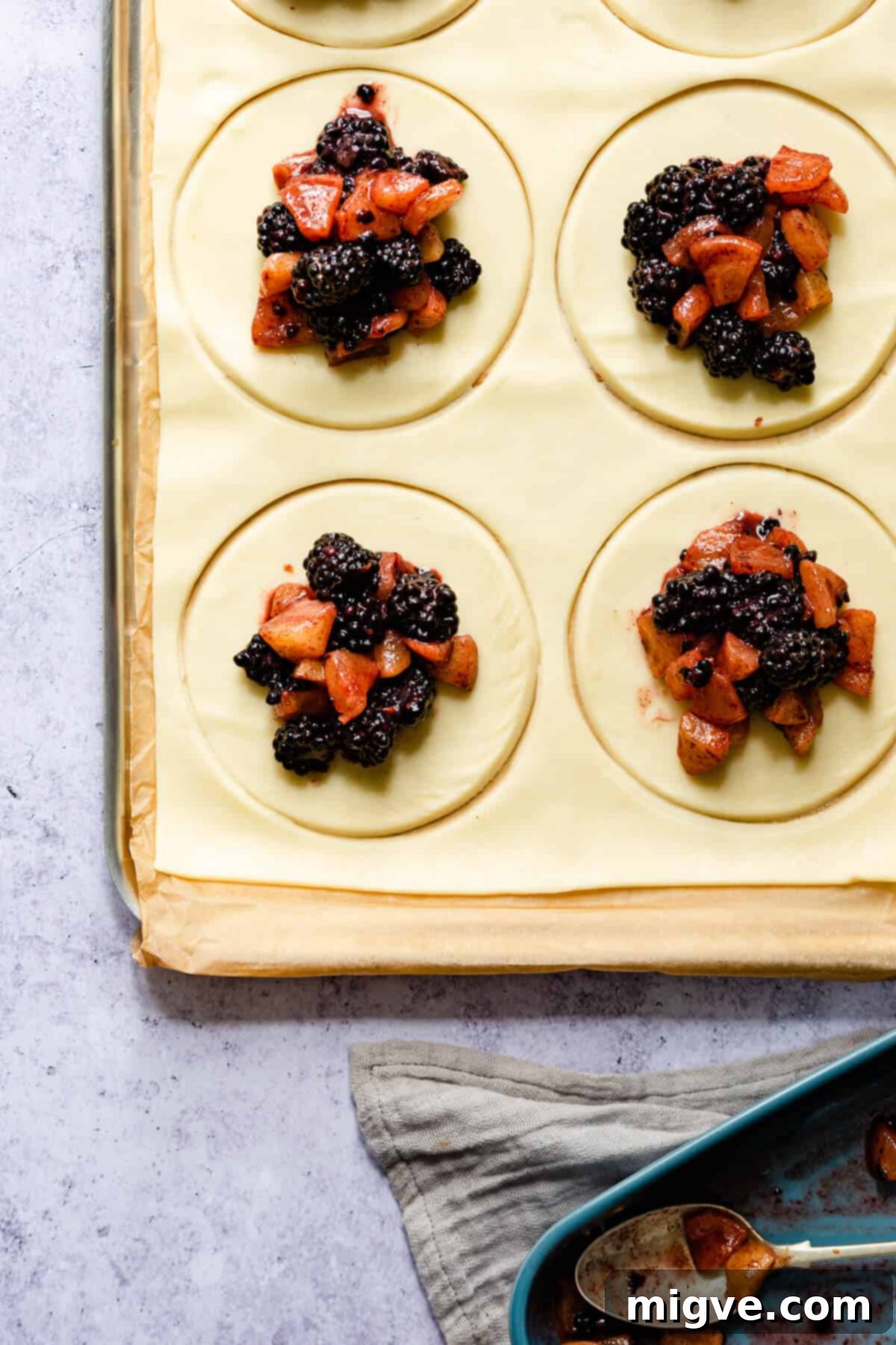 top view close up of pastry circles topped with spiced apple and blackberry filling