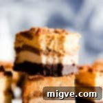 side close up at two slices of pumpkin cheesecake bars stacked on top of each other