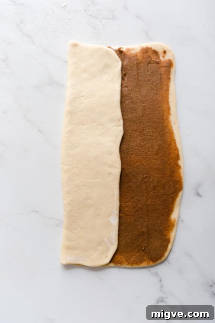 overhead shot of a large rectangle of dough being folded