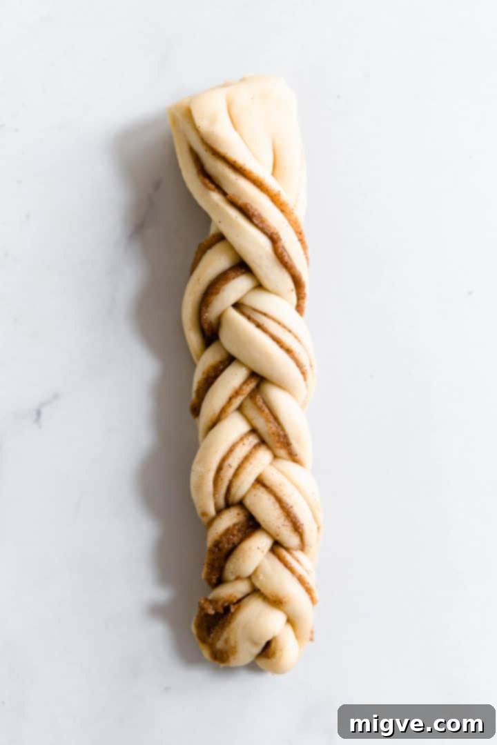 overhead close up of a strip of dough twisted into plait