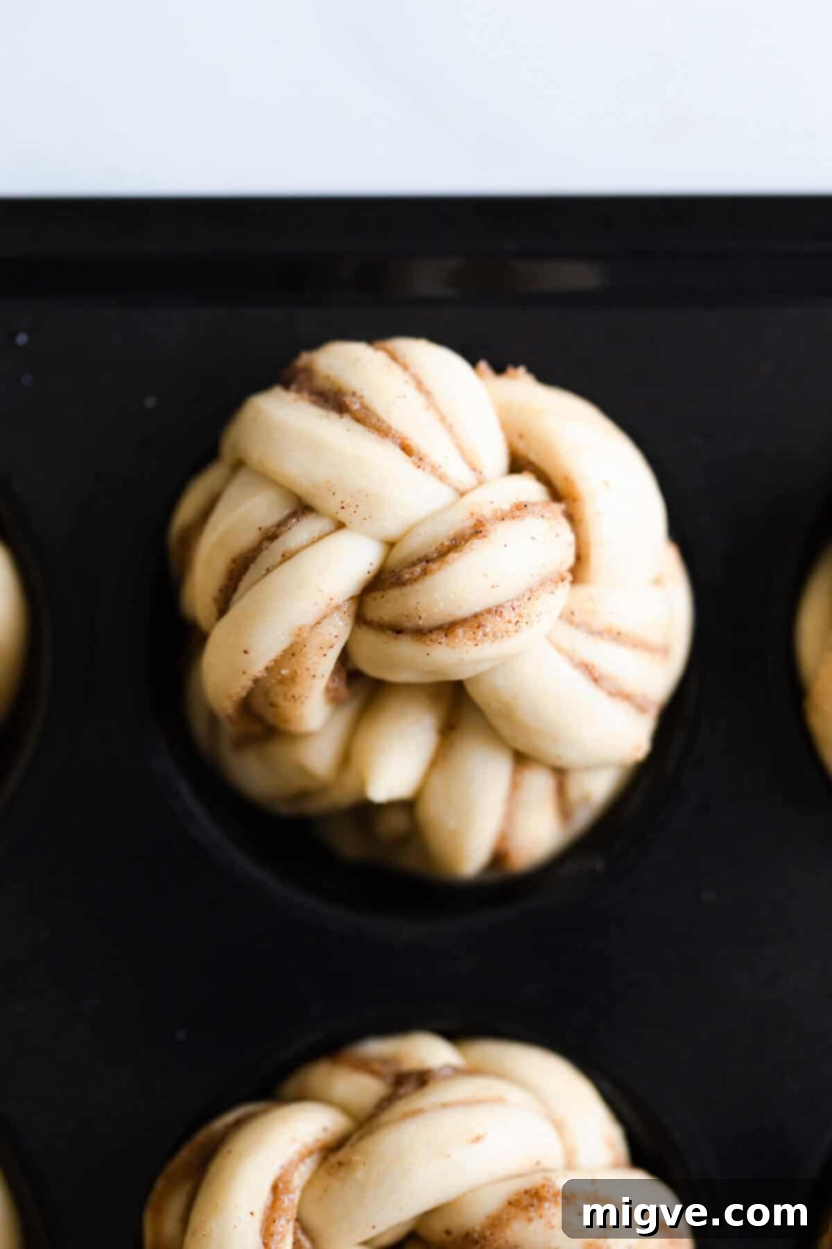 top view close up at twisted cinnamon bun in baking tray