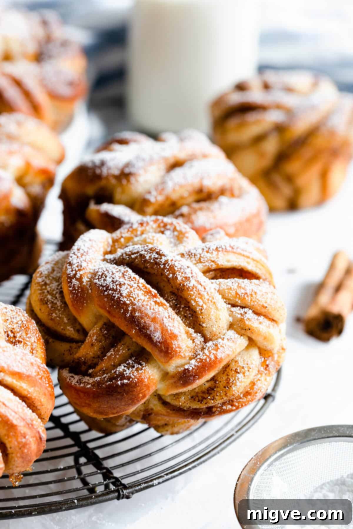 side super close up at twisted cinnamon roll on a wire rack
