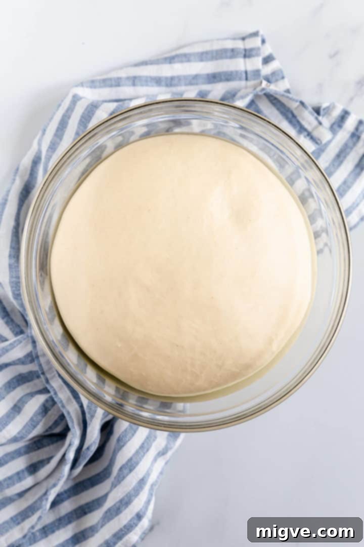 top view of a soft dough doubled in size in a large bowl