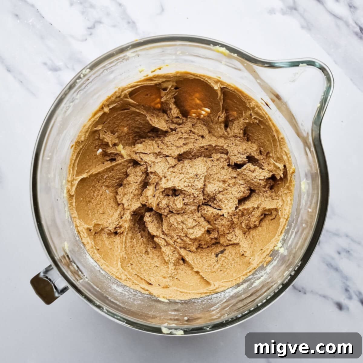 a glass bowl with creamed sugar, eggs and coffee mixture.