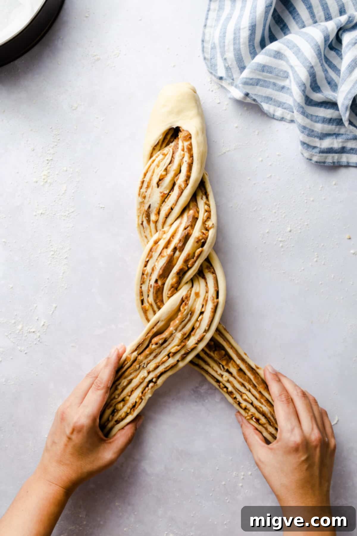 top view of a person twisting the dough for cinnamon and hazelnut bread