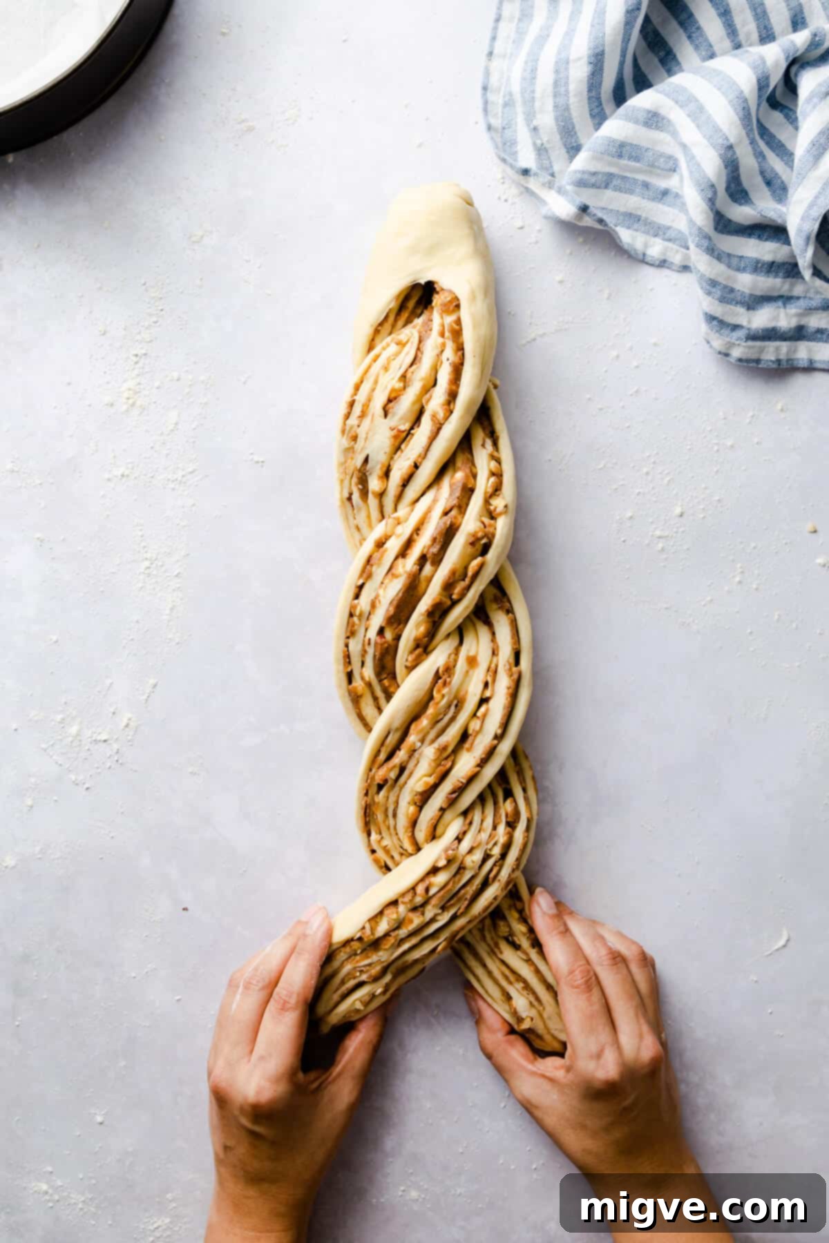 top view of a dough being twisted for cinnamon and hazelnut bread