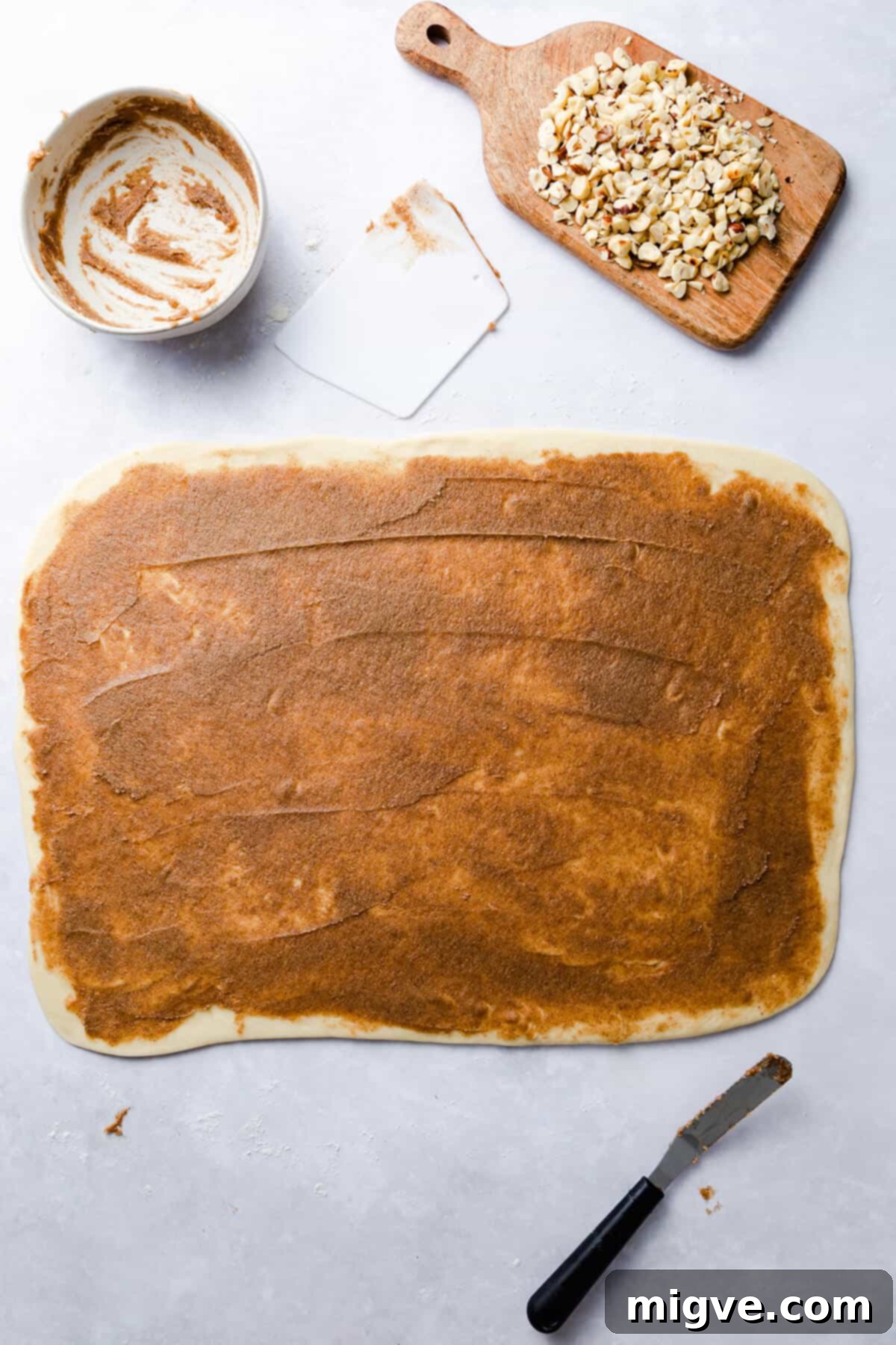 top view of dough for twisted cinnamon bread covered with cinnamon butter