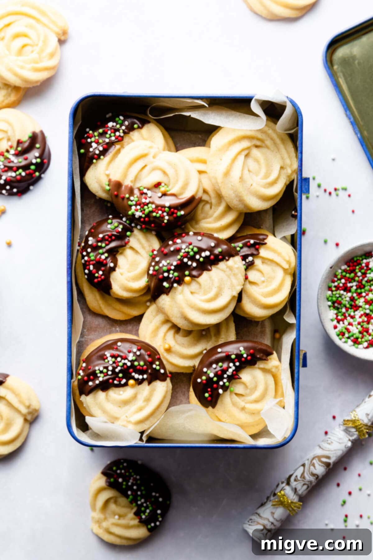 Buttery Danish Cookie Perfection 2 Classic Danish butter cookies neatly arranged inside a metal tin on a light background.