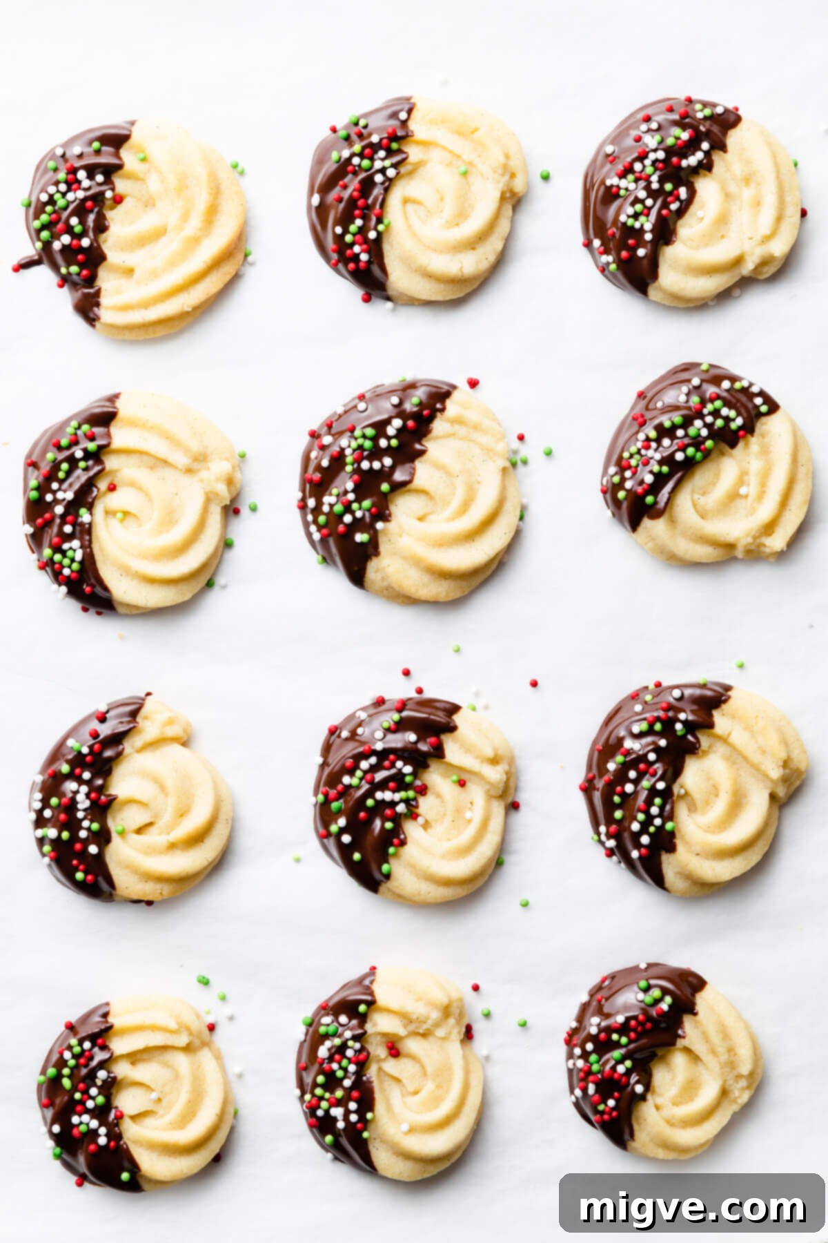 Buttery Danish Cookie Perfection 11 Delicious chocolate-dipped butter cookies adorned with vibrant, festive sprinkles.