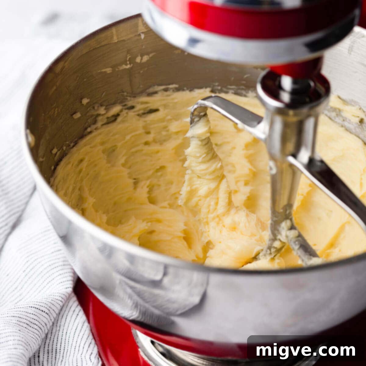 Buttery Danish Cookie Perfection 4 A mixing bowl filled with butter that has been whipped until pale and fluffy.