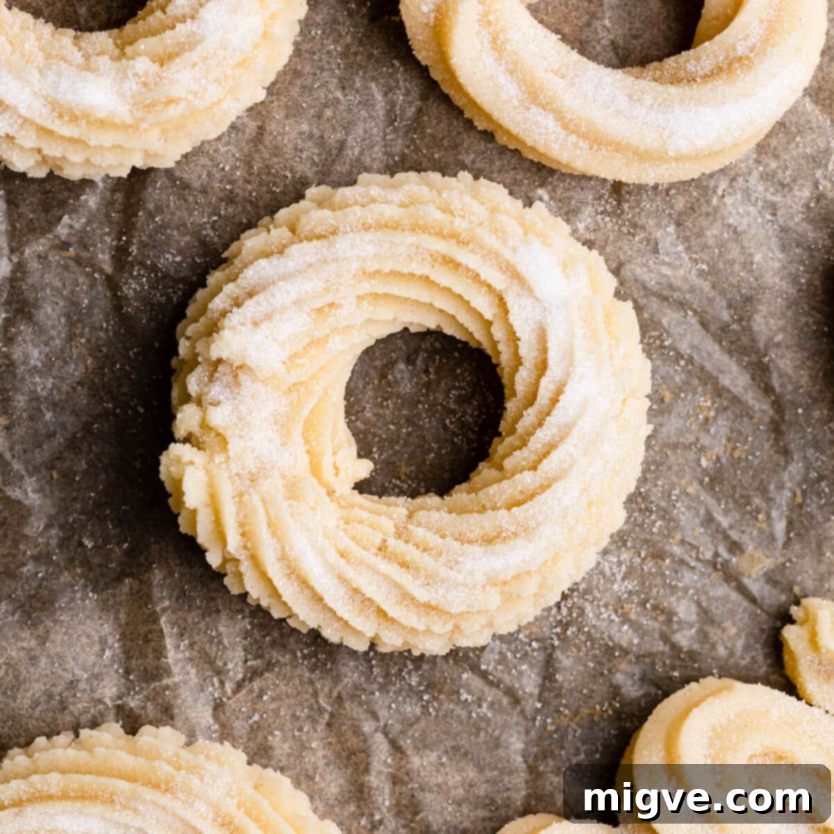 Buttery Danish Cookie Perfection 7 An unbaked butter cookie, shaped into a perfect ring and lightly sprinkled with sugar, ready for the oven.