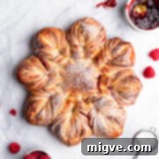 top view close up of a festive raspberry star bread dusted with icing sugar