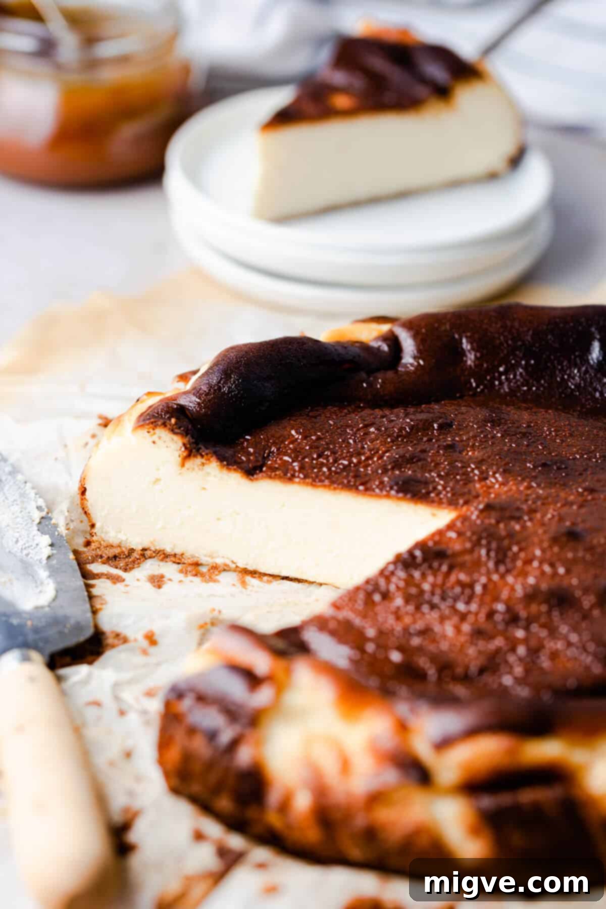 side angle shot revealing the creamy texture of cheesecake on a plate.