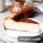 slice of burnt Basque cheesecake on a stack of small plates, ready to be served.