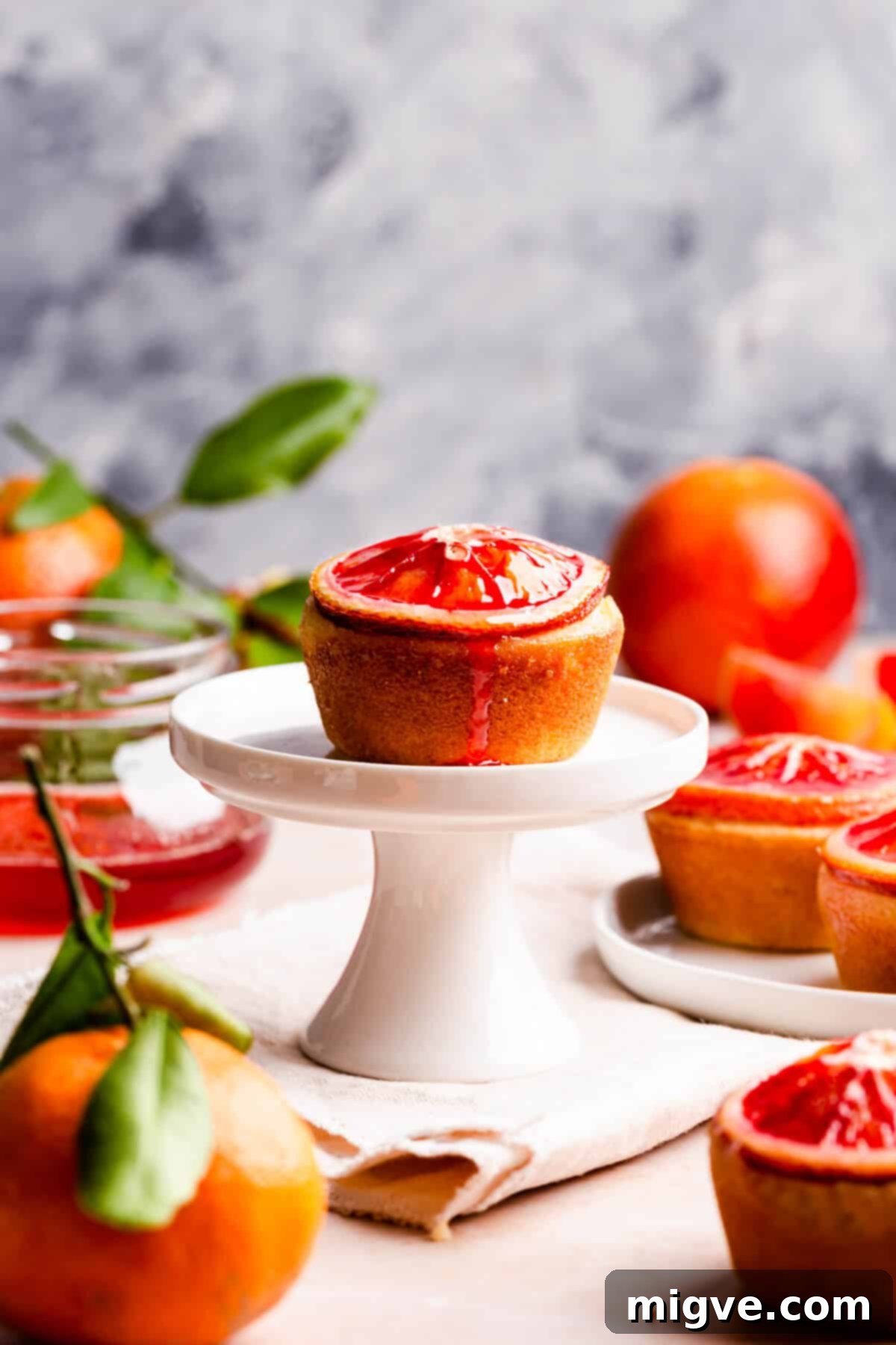 straight ahead shot of single blood orange and semolina cake on a mini cupcake stand