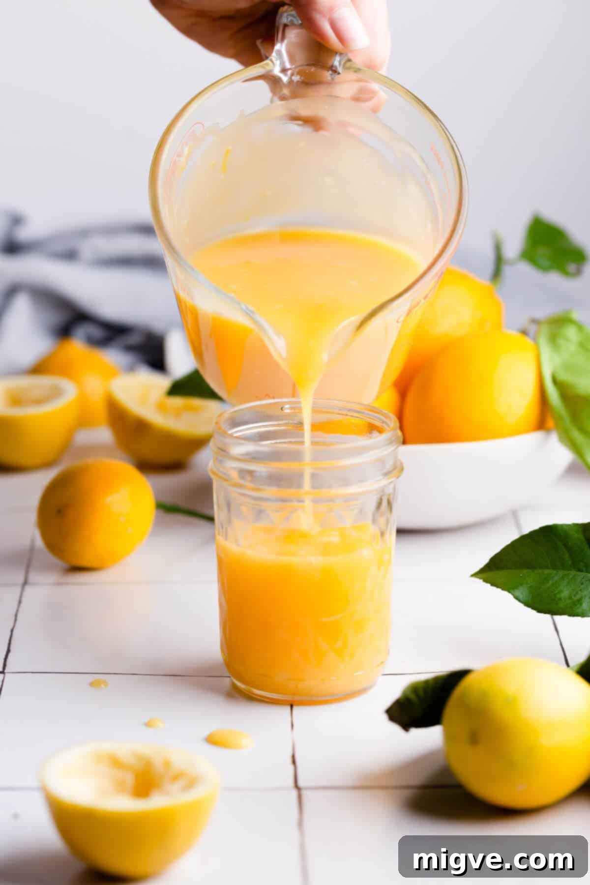 Handcrafted Lemon Zest Delight 3 45 degree angle of homemade curd being poured into a small glass jar