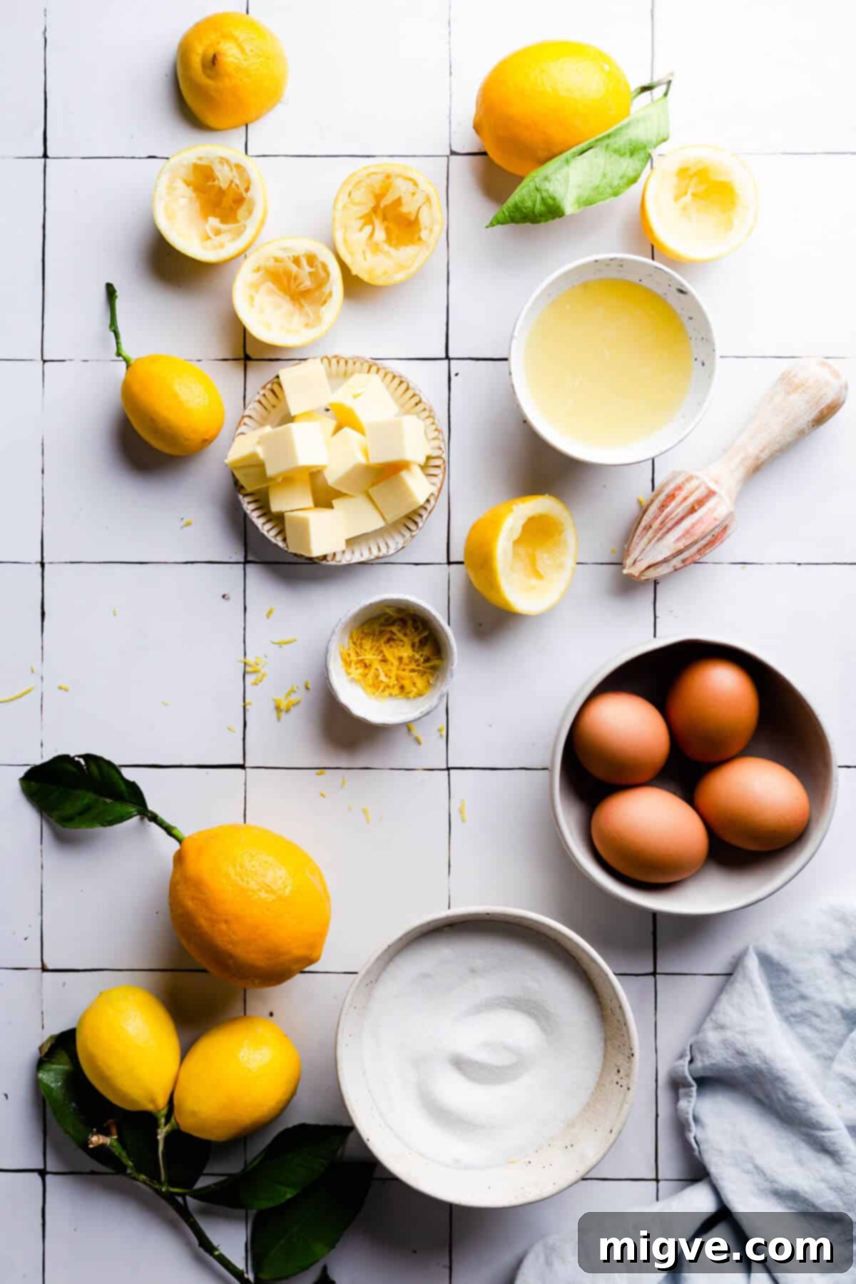 Handcrafted Lemon Zest Delight 5 overhead shot of the ingredients for homemade lemon curd on a white tile surface
