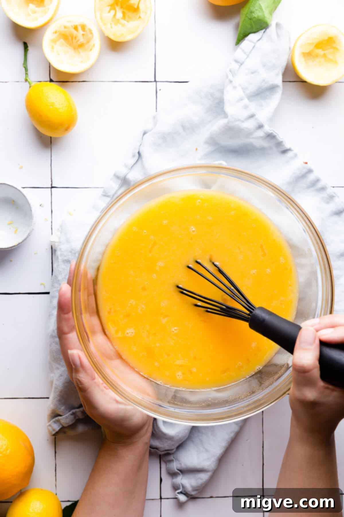 Handcrafted Lemon Zest Delight 9 overhead shot of a large glass bowl with curd mixture being whisked