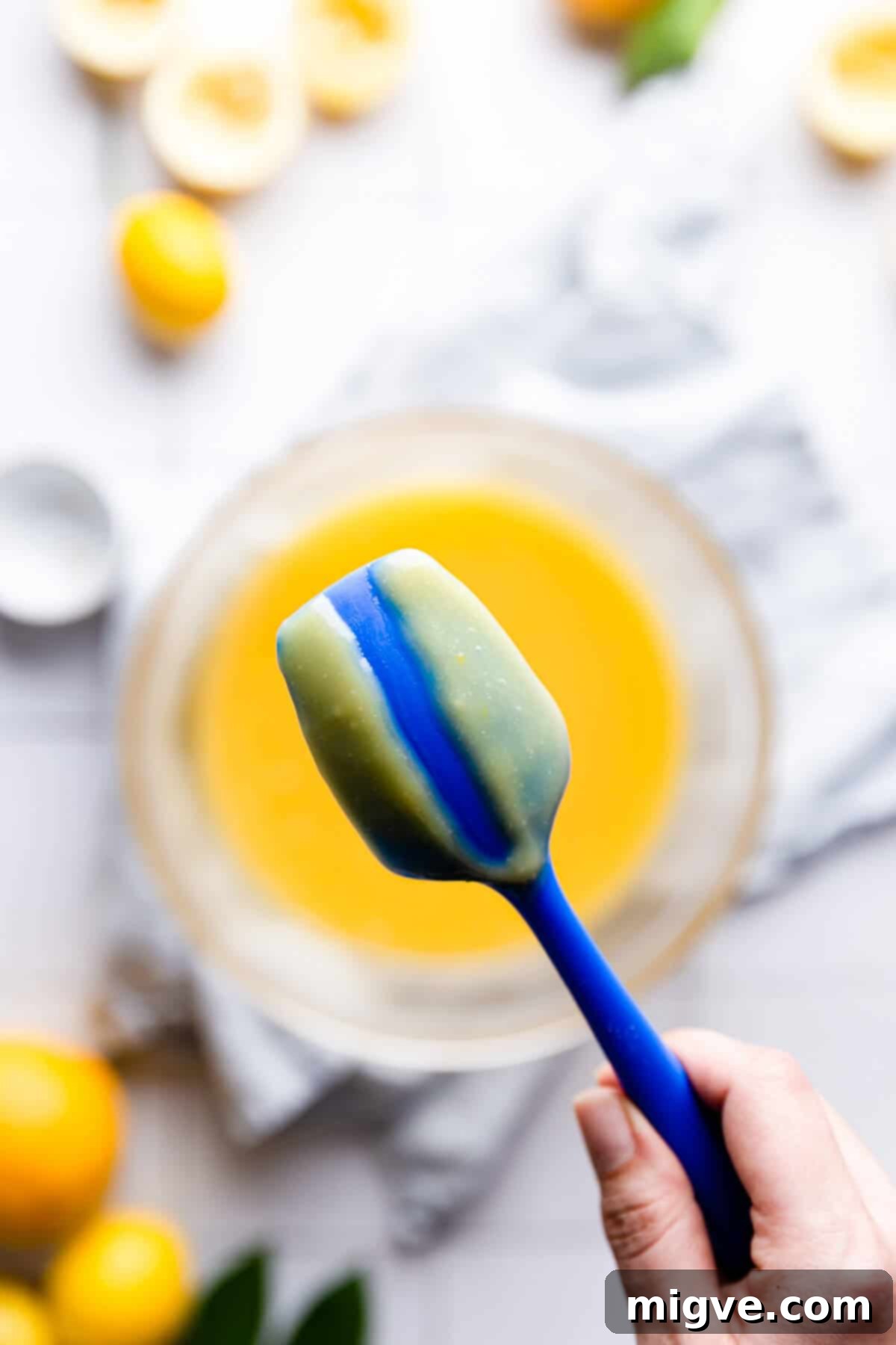 Handcrafted Lemon Zest Delight 10 top view of a back of small spatula covered in lemon curd