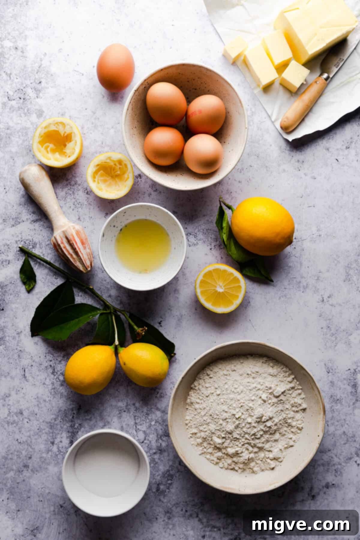 Overhead shot of the ingredients for lemon curd slices, neatly arranged on a rustic surface.