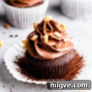 45 degree angle super close up at a chocolate cupcake topped with chocolate buttercream