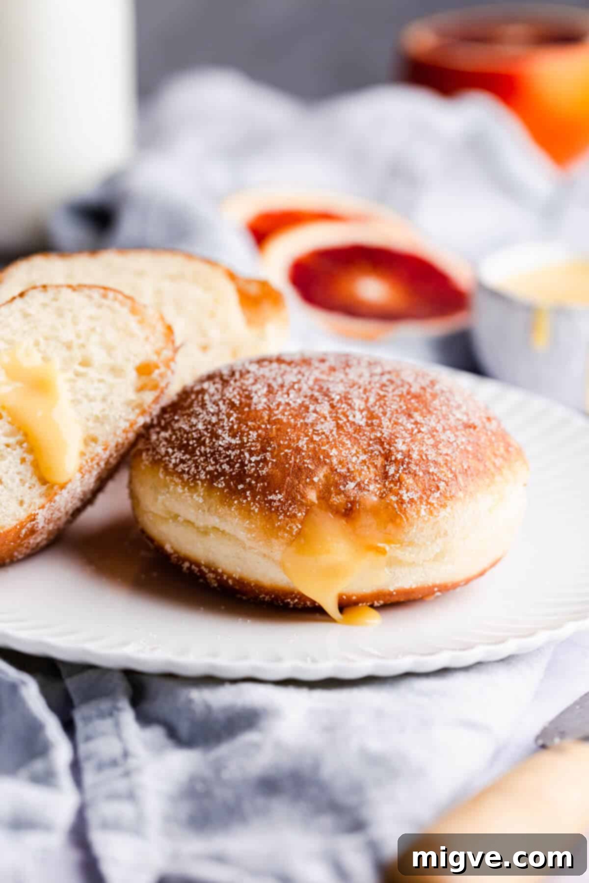 Handcrafted Doughnut Bliss 3 A vibrant display of freshly fried small batch doughnuts, glistening with a sugar coating, ready to be filled and enjoyed. The soft texture and golden hue are clearly visible.