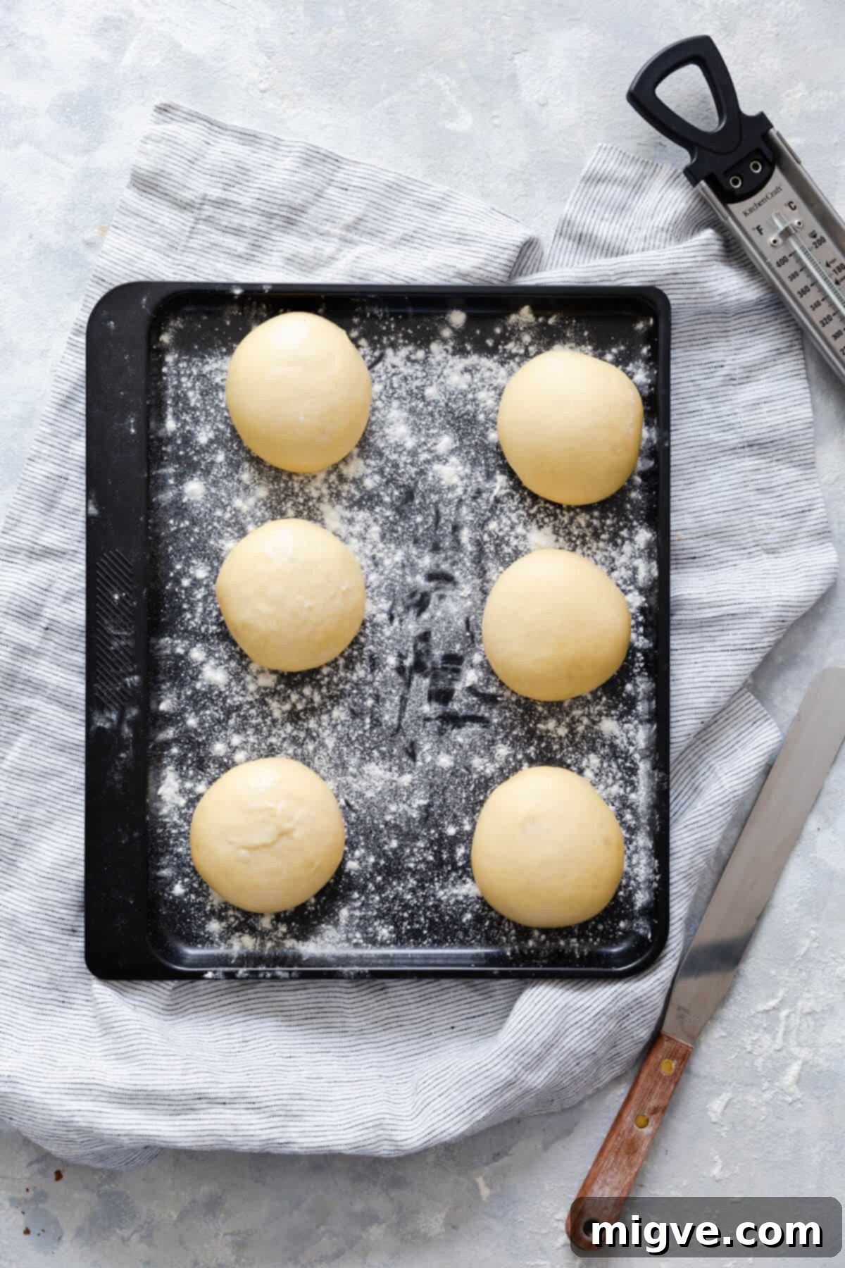 Handcrafted Doughnut Bliss 7 Top-down view of six perfectly risen dough balls, light and airy, for small batch doughnuts, indicating they are ready for frying.