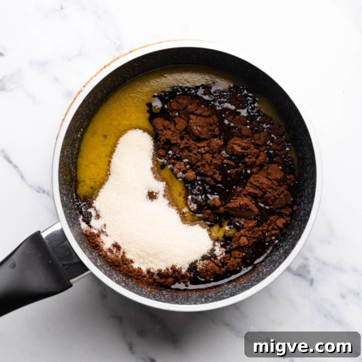 cocoa and sugar added into small saucepan with melted butter and guinness stout.