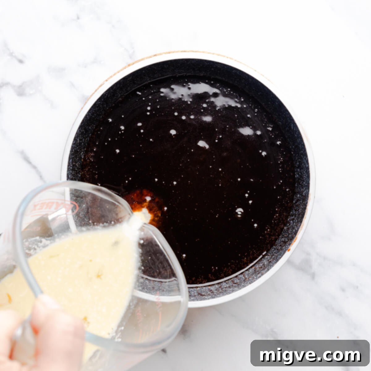 wet ingredients for the chocolate Guinness cake being mixed together in a small saucepan.