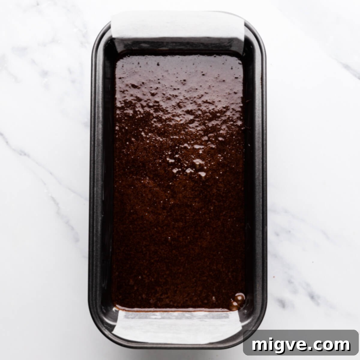 small loaf tin with cake batter inside.