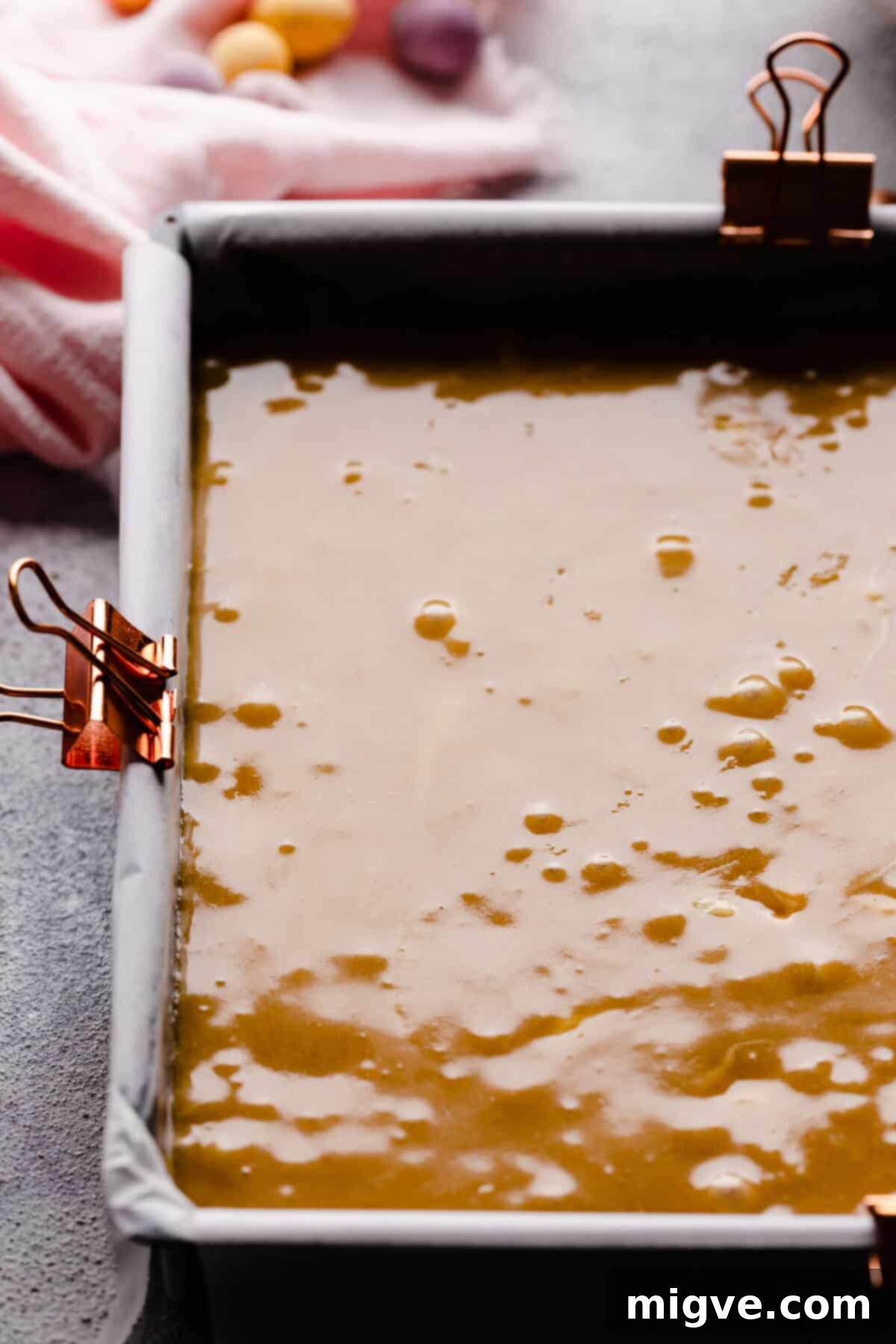 Speckled Spring Blondies 7 Top-down close-up photo of a baking tin filled with smooth blondie batter, ready to be baked.