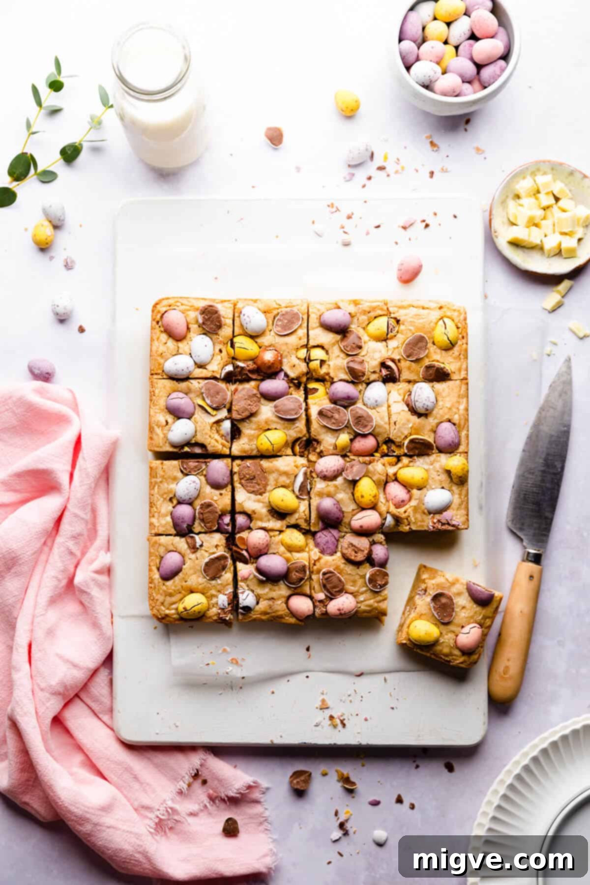Speckled Spring Blondies 8 Top-down view of a tray of freshly baked mini egg blondies, neatly cut into 16 squares and garnished with colorful mini eggs.