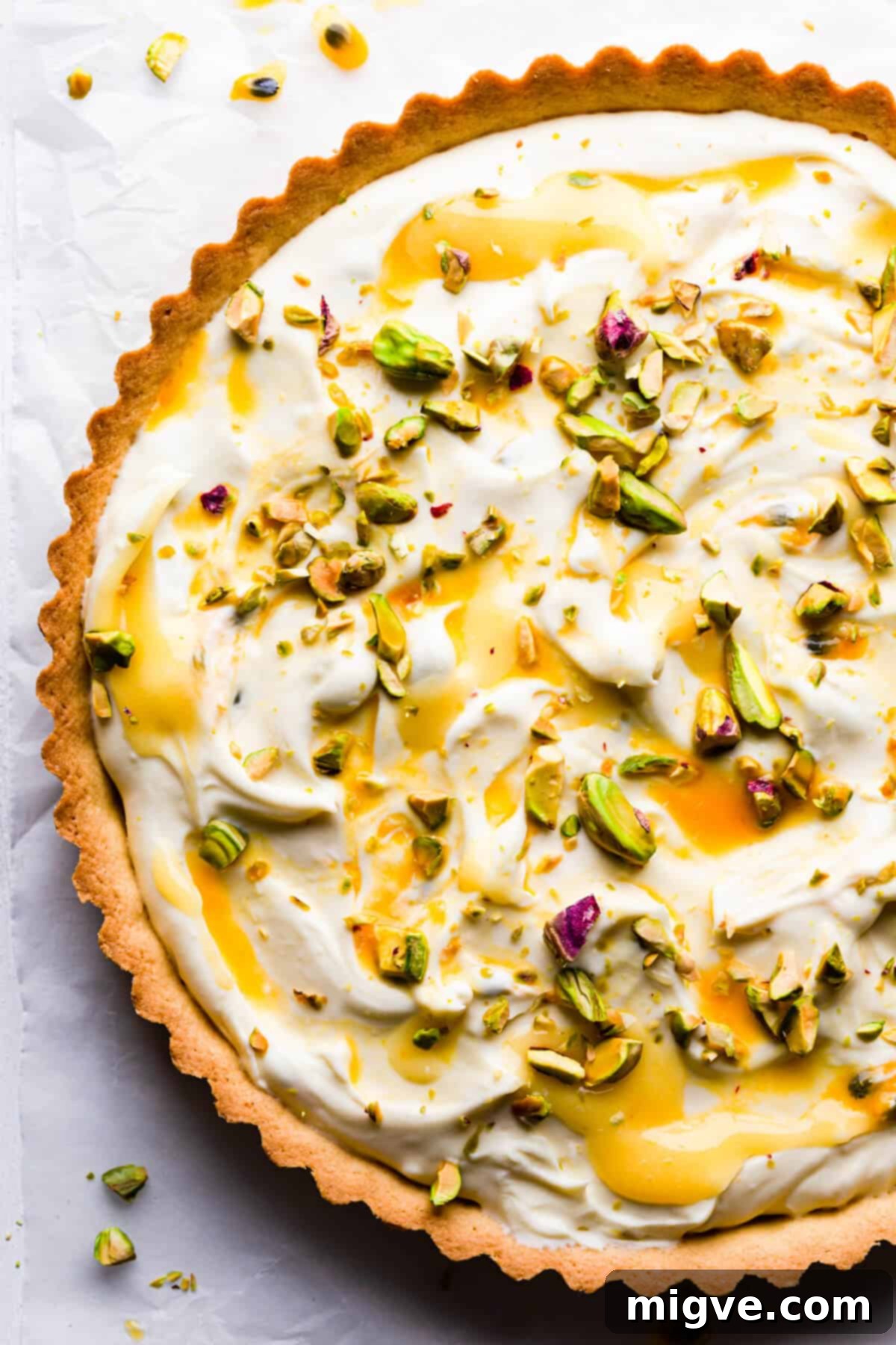 top view super close up at a sweet tart with lemon curd, mascarpone and pistachios