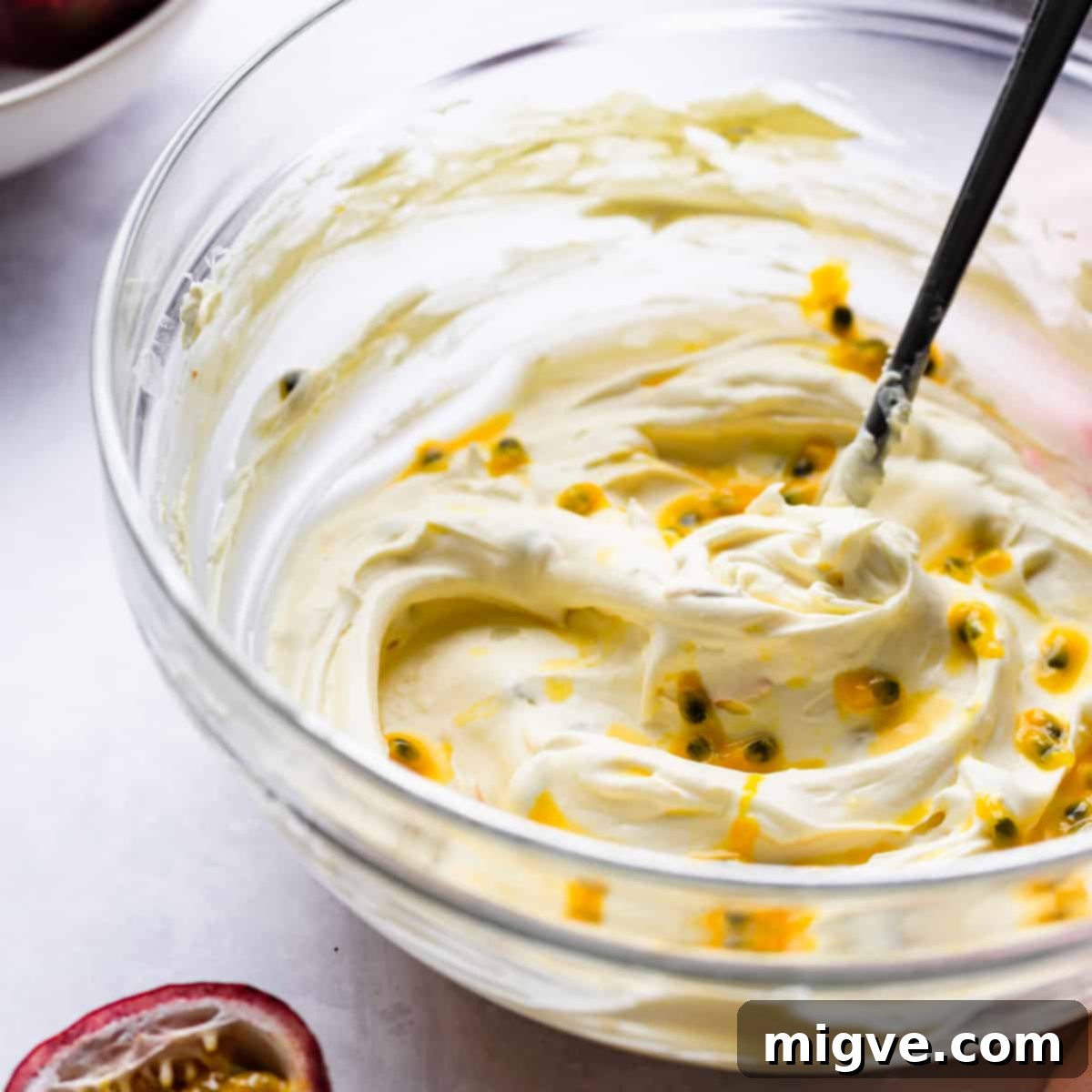 bowl with whipped mascarpone cheese and passion fruit seeds.