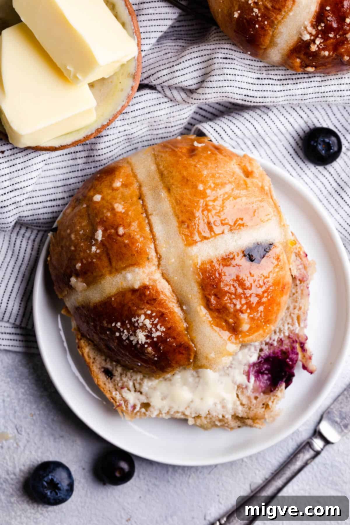 Luscious Blueberry Hot Cross Buns 12 top view close up photo of blueberry hot cross bun with butter