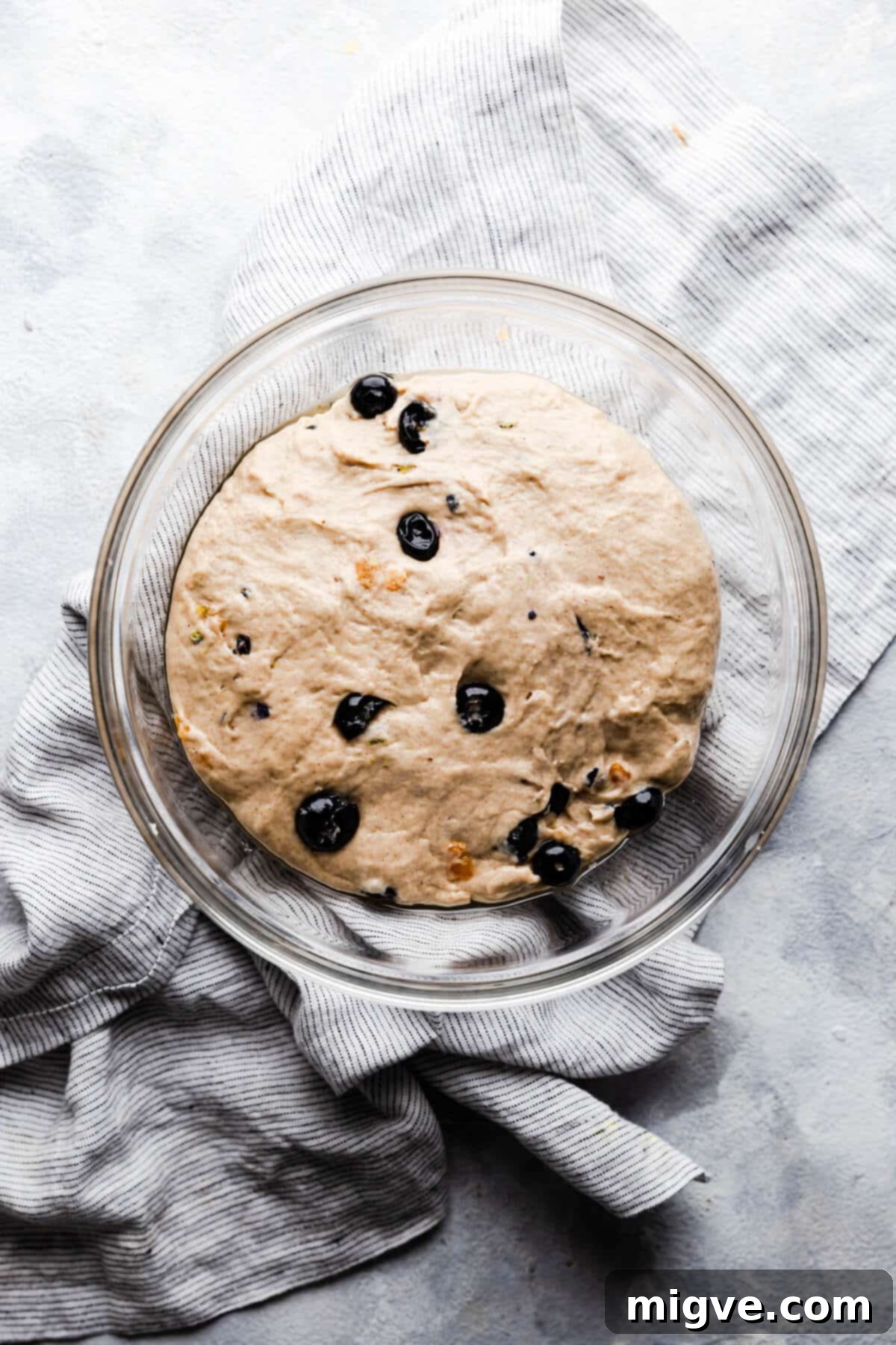 Luscious Blueberry Hot Cross Buns 5 top view of a glass bowl with dough proving