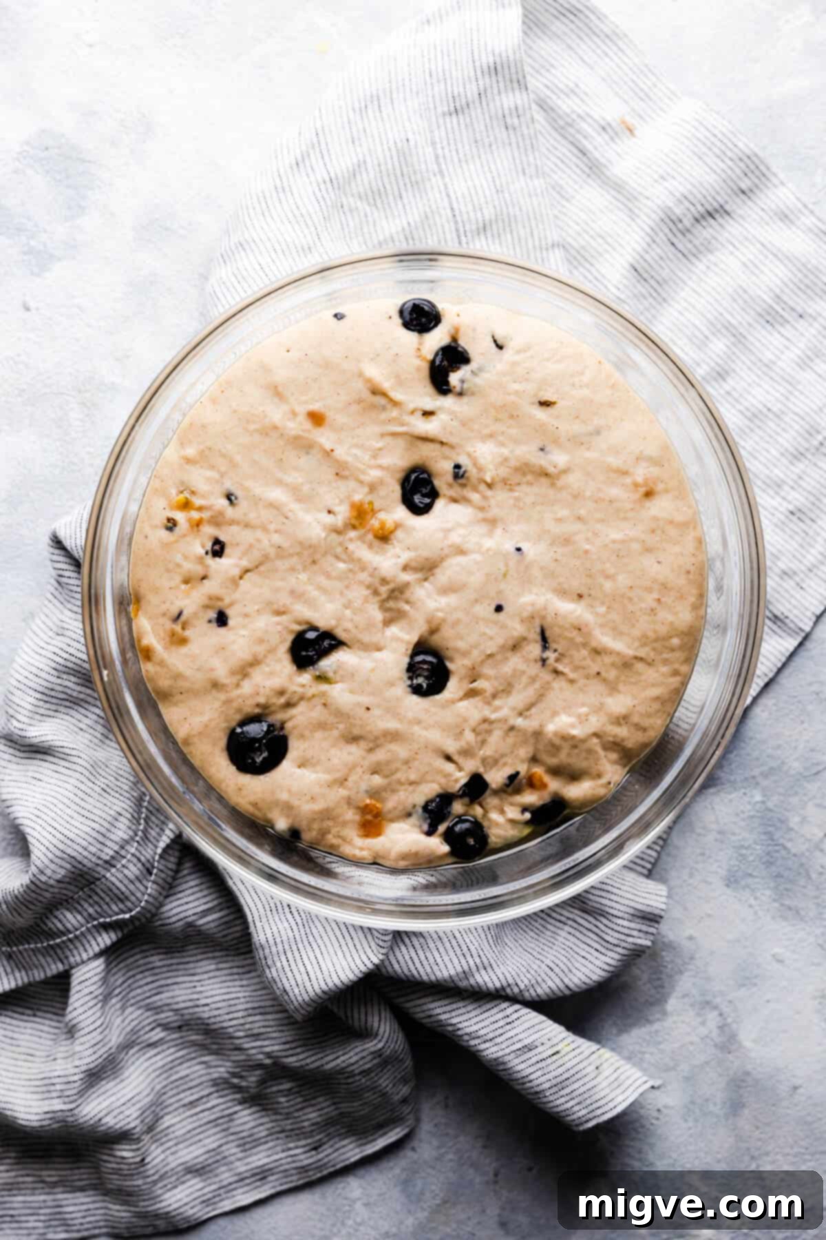 Luscious Blueberry Hot Cross Buns 6 top view of a glass bowl with risen dough