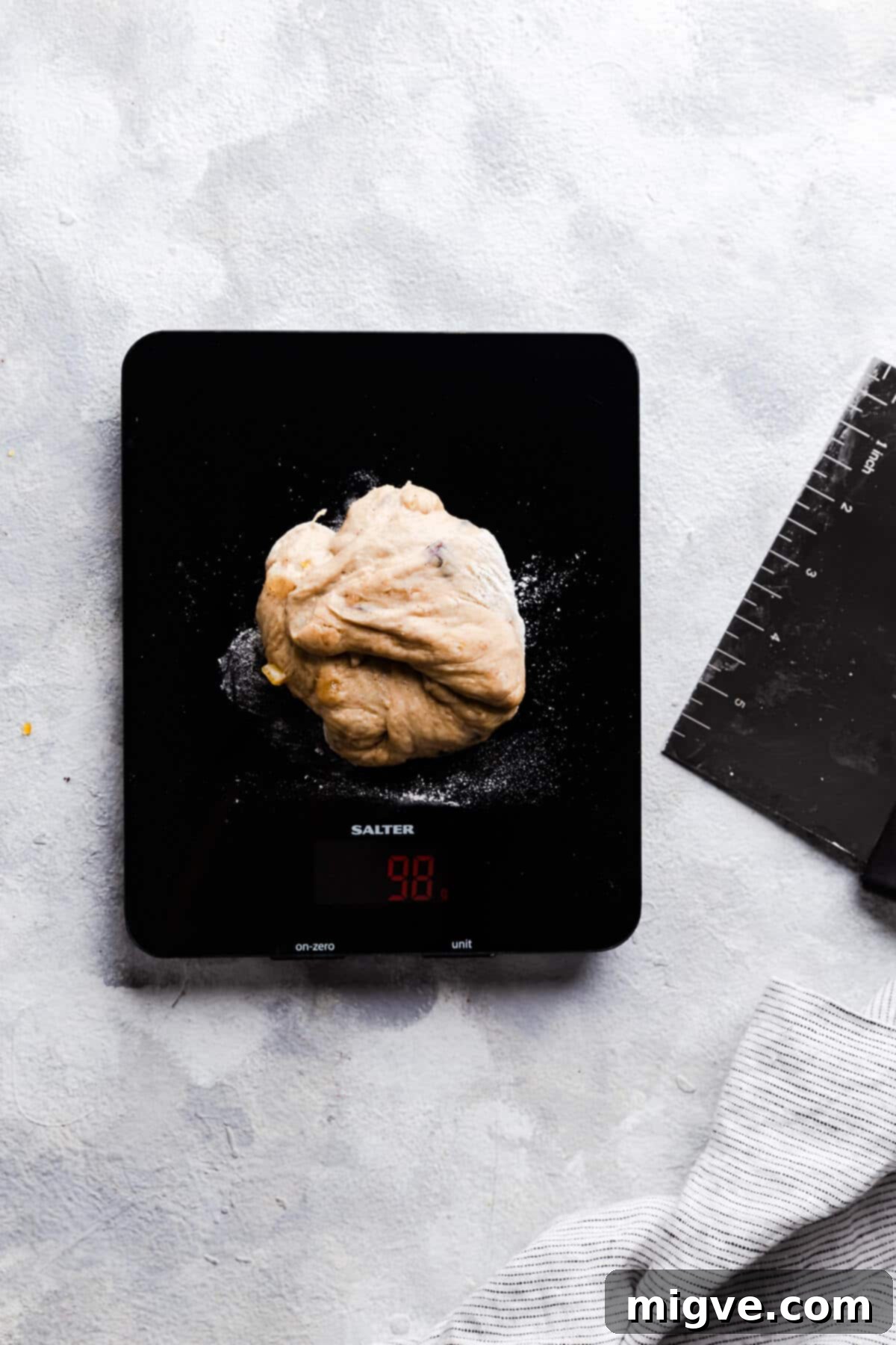 Luscious Blueberry Hot Cross Buns 7 top view of digital kitchen scales with piece of dough on top