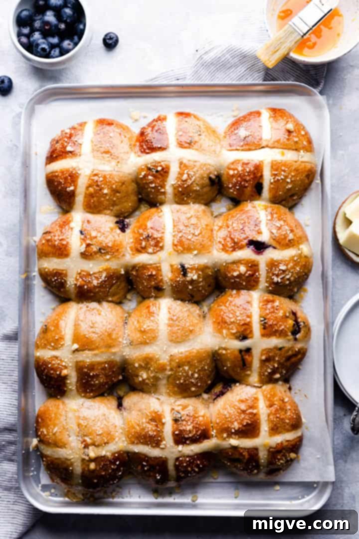 Luscious Blueberry Hot Cross Buns 10 overhead shot of 12 blueberry hot cross buns on a baking tray